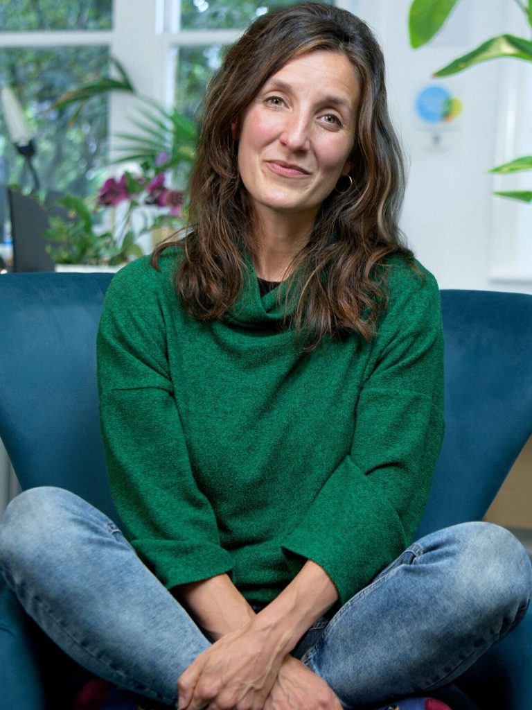 China Mills seated on a couch